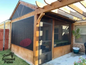 Custom screened patio with retractable shades keeping a Texas backyard cool in summer
