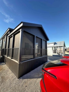 Exterior of a black screened porch addition on a Fishtrap tiny home in North Texas