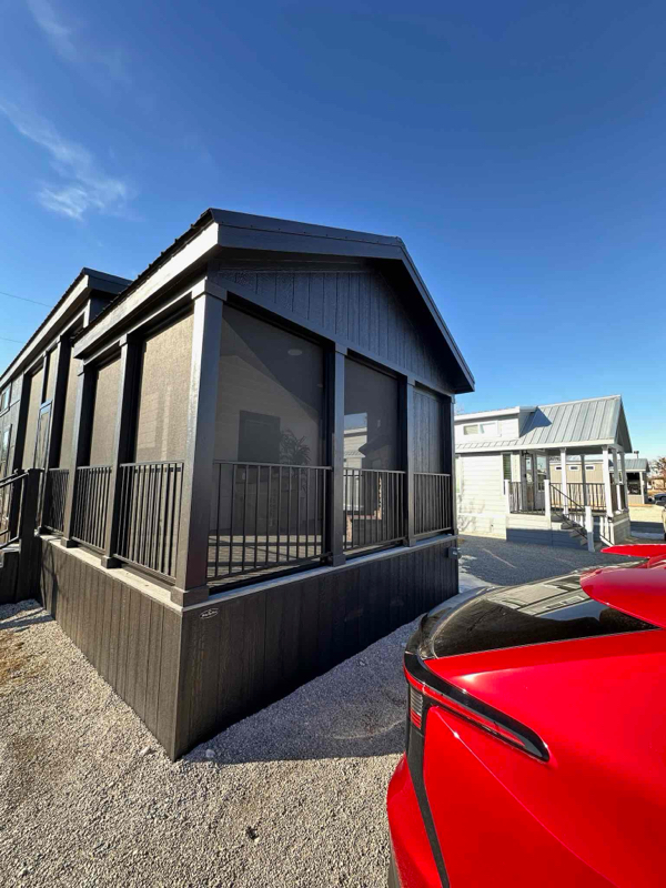 Exterior of a black screened porch addition on a Fishtrap tiny home in North Texas